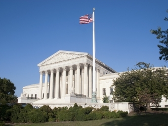 Supreme Court Building will American flag in front