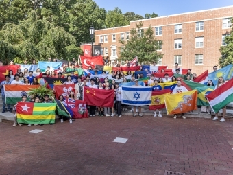 International Pre-Orientation students holding flags