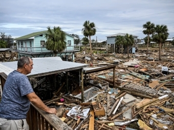 David Hester inspects damages of his house on Saturday after Hurricane Helene made landfall in Horseshoe Beach, Fla.