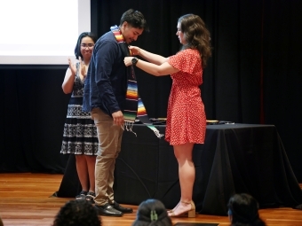 a group of students putting cords on on a stage