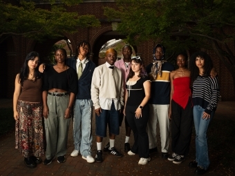 a group of students standing together on a college campus