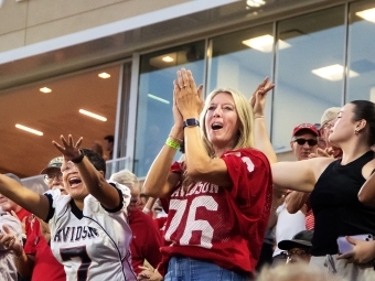 fans in a football stadium wearing Davidson College gear