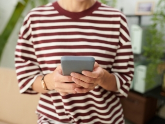 Student in striped shirt doomscrolling