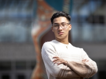 a young man with glasses and black hair