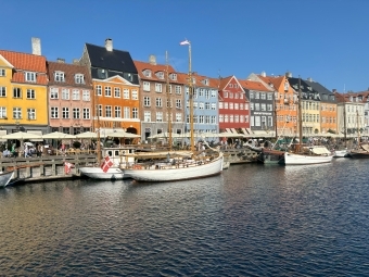 a view of historic Copenhagen - colorful houses and boats along a river