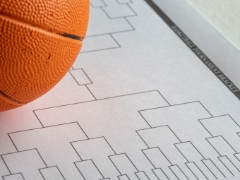 a basketball bracket on a piece of paper with a basketball next to it