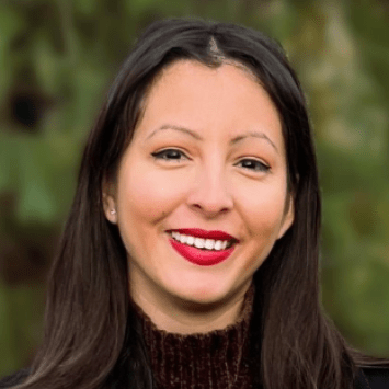 a young woman with dark hair smiles