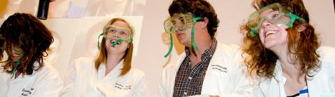 Four students wearing lab goggles