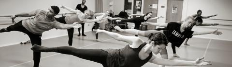 Students take complex dance pose during a masterclass