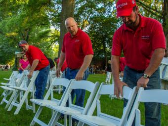 Physical Plant employees set up chairs for the Commencement ceremony
