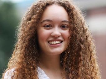 a young white woman with curly reddish brown hair
